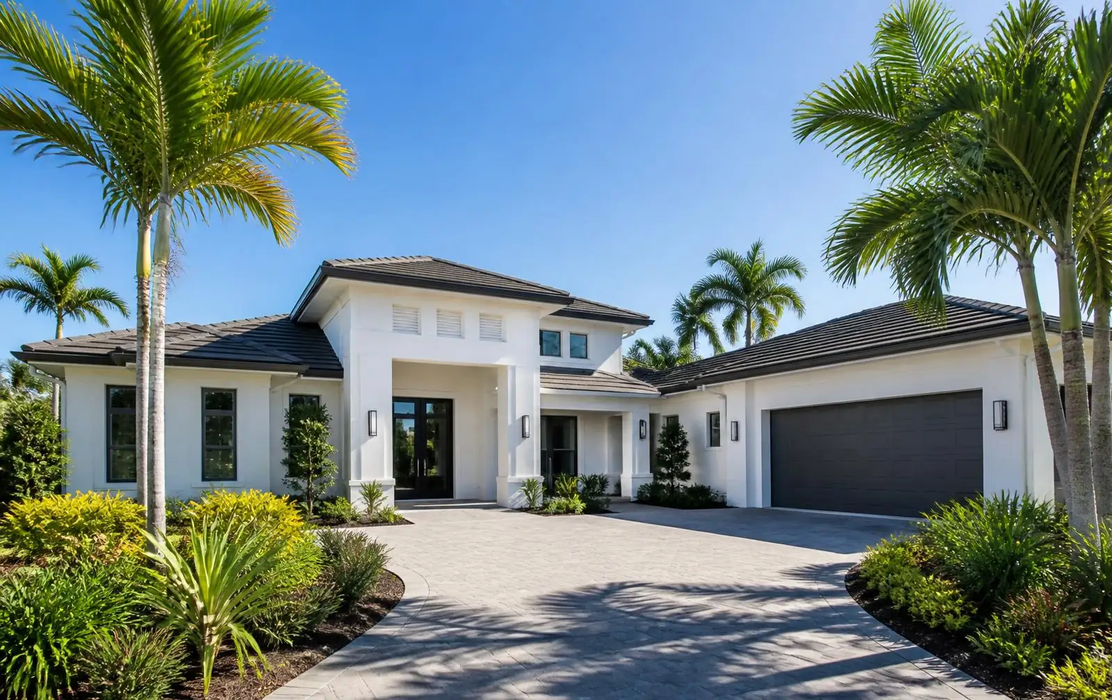 Crisply repainted white coastal home exterior with palms in South Florida