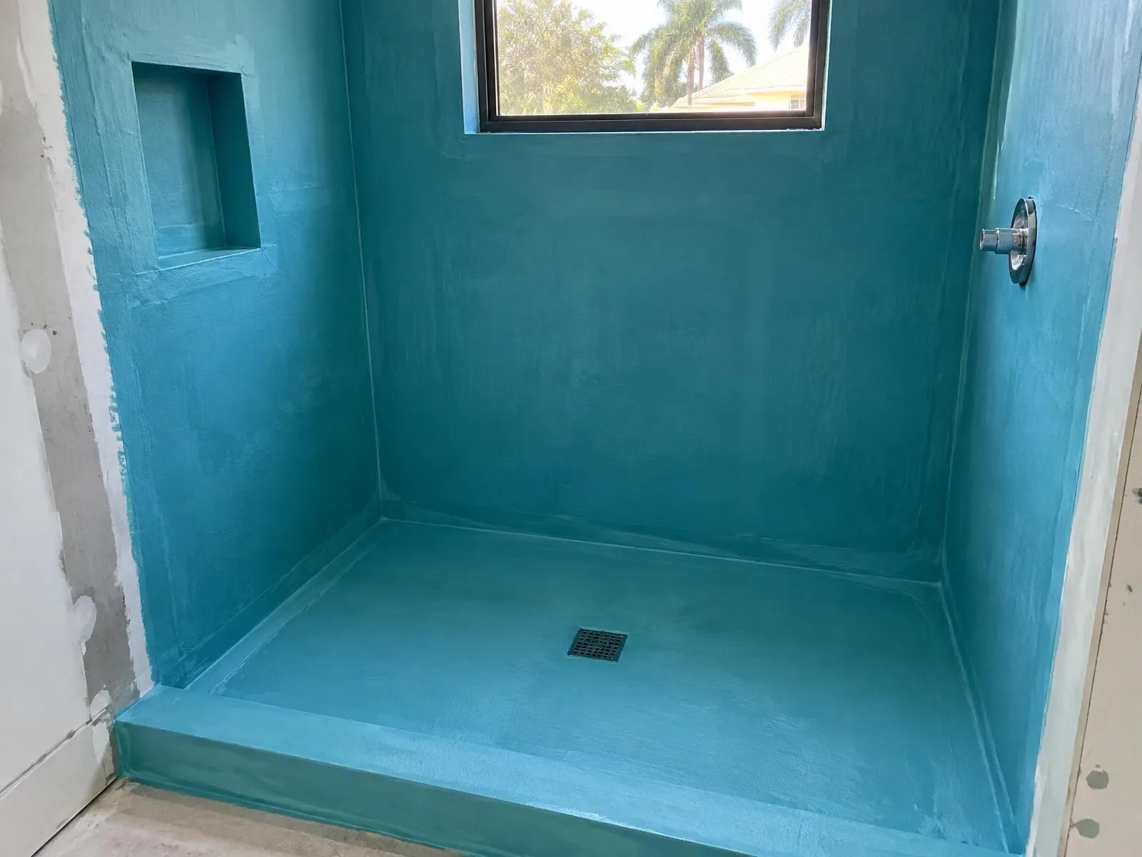 Shower walls and floor covered with waterproofing membrane before tile installation