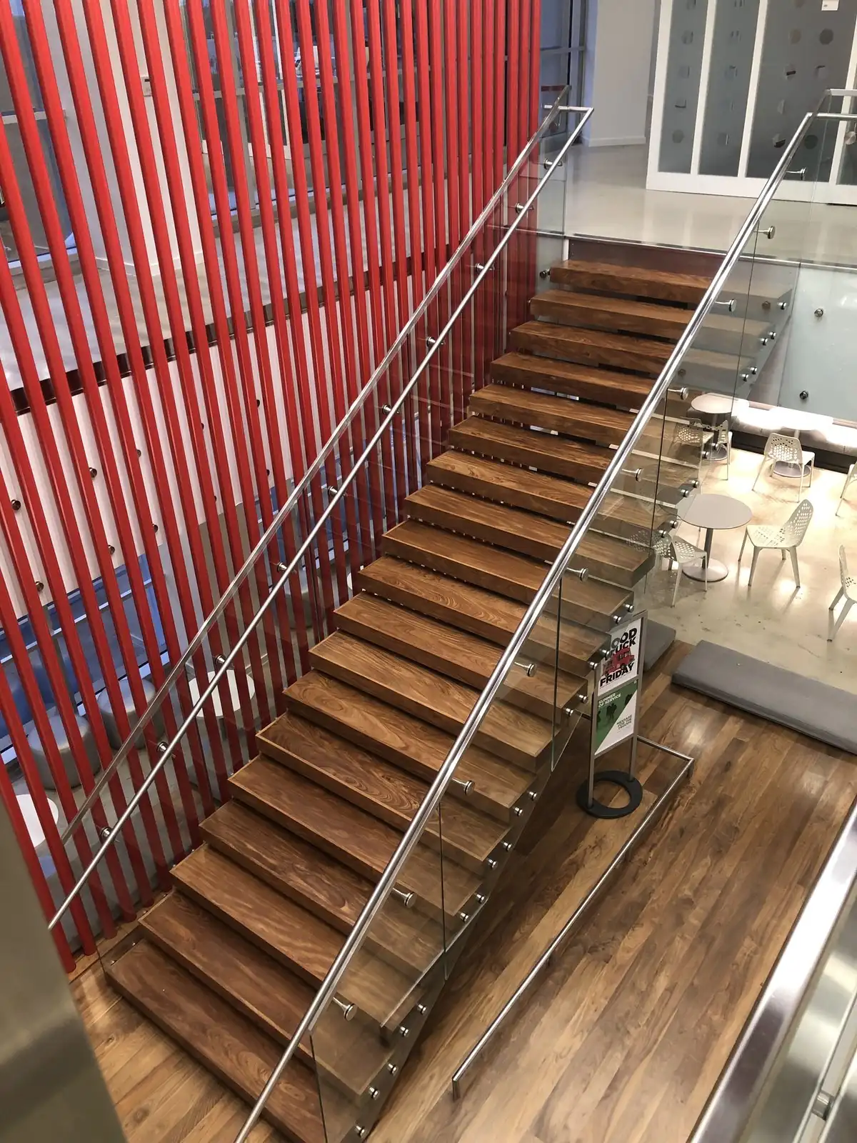Floating wood staircase with glass railing in a commercial office
