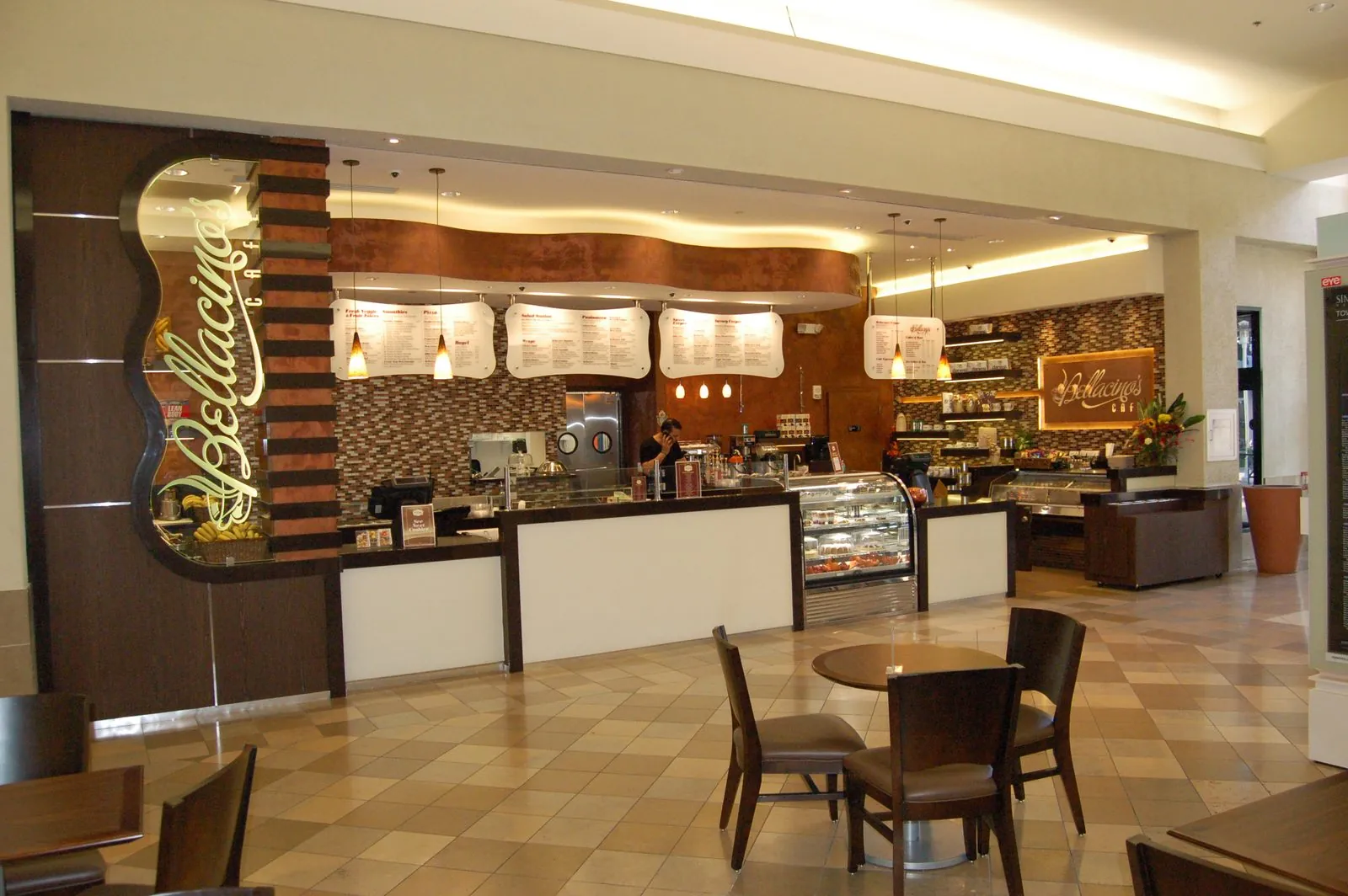 Finished cafe interior with service counter, display case, and seating